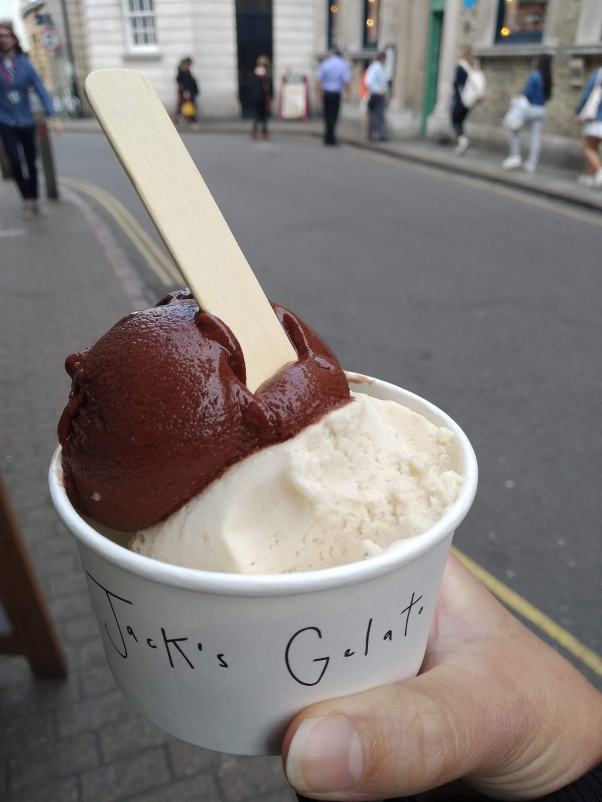 Two scoops of ice cream in a Jacks Gelato branded cup.